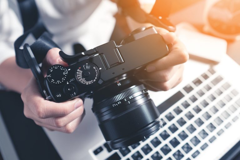 High Angle Of Person With Camera And Laptop