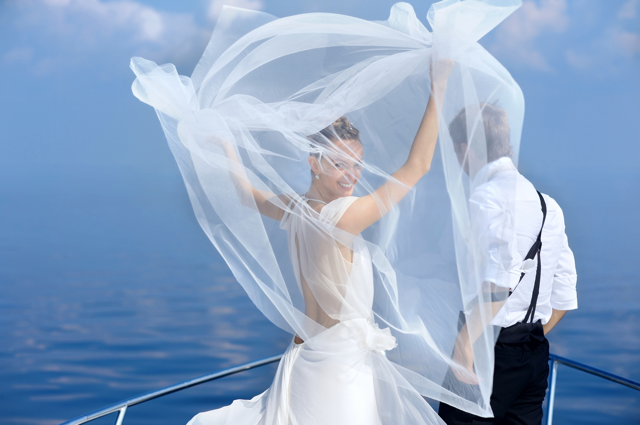 Happy bride and groom on a yacht