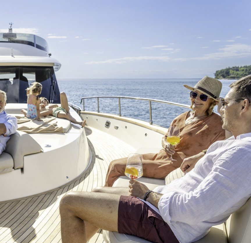 Multigenerational family enjoying cruise on yacht on sunny day